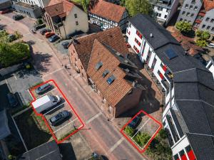 an overhead view of a building with red parking spaces at Colleen Apartments Wesertal in Porta Westfalica