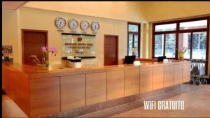 a lobby with a bar with clocks on the wall at VISTA AZUL Prime in Domingos Martins