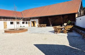 a pavilion with a table and benches in front of a building at Das Max & Fritz in Wegscheid