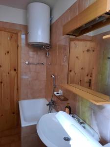 a bathroom with a sink and a toilet and a mirror at Mansarda Carona in Carona