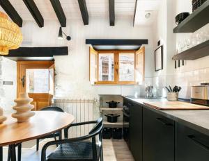 a kitchen with a table and chairs and a counter at El Nido Rural Boutique Villa in La Focella