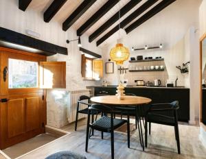 a kitchen and dining room with a table and chairs at El Nido Rural Boutique Villa in La Focella +7 photos