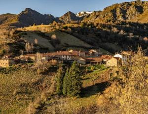 a village on a hill with mountains in the background at El Nido Rural Boutique Villa in La Focella