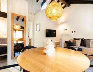 a dining room with a table and a living room at El Nido Rural Boutique Villa in La Focella