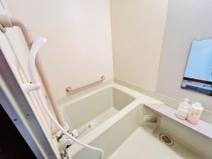 a hospital room with a bath tub and a window at Hokkaido Wander House in Ashibetsu +21 photos