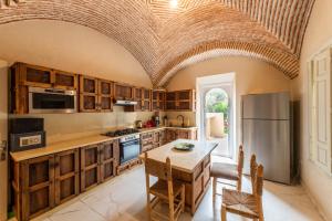 a kitchen with a table and a refrigerator at Villa Aurea Marrakech in Gzoula