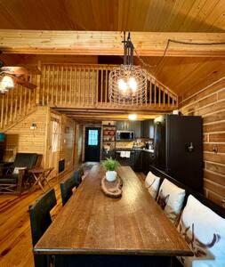 a dining room with a wooden table and chairs at Cedar Gap Hideaway in Indiana in Birdseye