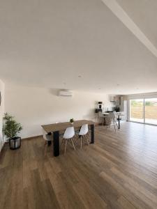a large white room with a table and chairs at Villa Patja in Béziers