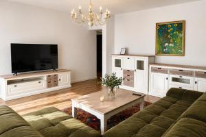 a living room with a couch and a table at KOA - Aparthotel in Braşov