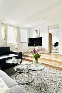 a living room with a couch and two tables at Das Stader Zuhause in Stade