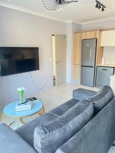 a living room with a couch and a table at Lagoon escape Apartment in Pretoria