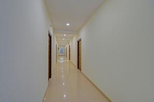 a hallway of a building with white walls and white floors at FabHotel GG Stays in Lingampalli
