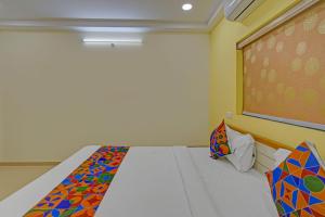 a room with a bed and a chalkboard at FabHotel GG Stays in Lingampalli