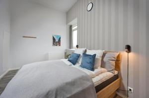a bedroom with a large bed with blue pillows at World Trade Center Ballerup - Forenom in Ballerup