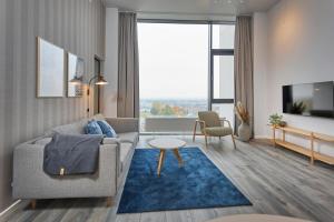 a living room with a couch and a table at World Trade Center Ballerup - Forenom in Ballerup