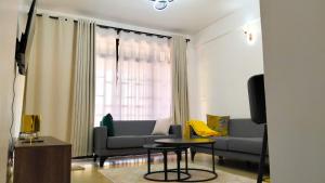 a living room with a couch and a table at Vito Haven suites in Busia
