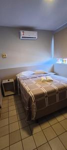 a bedroom with a bed in a room at Escuna Praia Hotel in João Pessoa