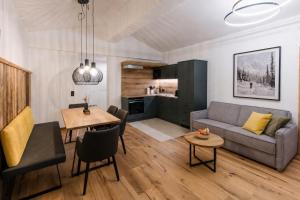 a living room with a couch and a table at ANN SUITES Appartements in Filzmoos