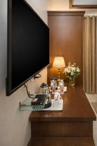 a flat screen tv hanging on a wall in a hotel room at Goyal Hotelirs - Hotel The Agra Grande, Agra in Agra