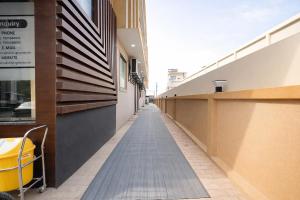 an empty hallway of a building with a sidewalk at FabHotel Prime Rosens in Māripat