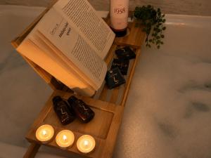 a book and candles on a table next to a bath tub at CENTRAL Apartment 84- free parking- spital Recuperare in Iaşi +49 photos