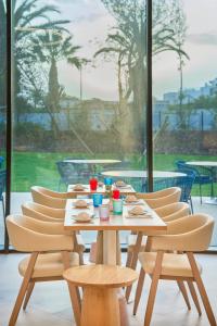 a table and chairs with food and drinks on it at The Editory Residence Lagos in Lagos