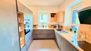 a large kitchen with a counter and a window at Whirlpool Sauna Pool Bad Ems in Bad Ems