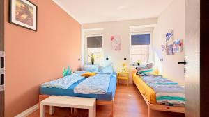 a bedroom with two beds and a table at Whirlpool Sauna Pool Bad Ems in Bad Ems