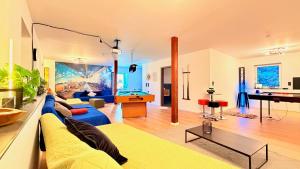 a living room with a blue couch and a piano at Whirlpool Sauna Pool Bad Ems in Bad Ems