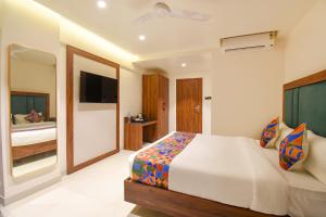a bedroom with a bed and a television in it at FabHotel Shourya Regency in Jāmb
