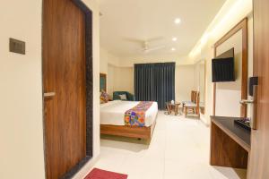 a hotel room with a bed and a desk at FabHotel Shourya Regency in Jāmb