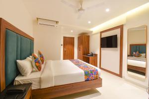 a bedroom with a bed and a television in it at FabHotel Shourya Regency in Jāmb
