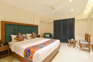 a bedroom with a large bed and a window at FabHotel Shourya Regency in Jāmb +27 photos