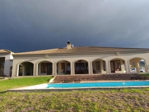 a large house with a pool in front of it at Barton Luxury Villas in Hermanus +10 photos