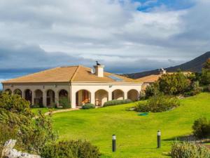 a house on a hill with a green lawn at Barton Luxury Villas in Hermanus