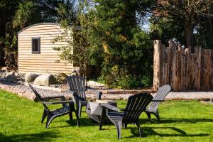 a group of chairs and a table in the grass at Ivy in Whithorn