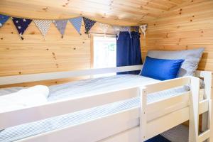 a bedroom with two bunk beds in a wooden cabin at Ivy in Whithorn