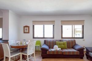 a living room with a couch and a table at Lamar Suites in Arinaga +18 photos