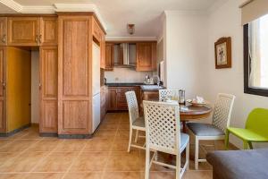 a kitchen with a table and chairs in a room at Lamar Suites in Arinaga