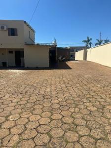a brick yard with a house and a building at Cardoso Palace Hotel Ouro Verde in Rio Verde