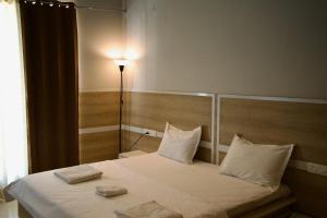a bedroom with a bed with two towels on it at Amur Stay 2 in Sohāna