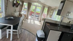 a kitchen and dining area of a tiny house at J&J Retreat in Morpeth