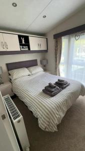 a bedroom with a bed with towels on it at J&J Retreat in Morpeth