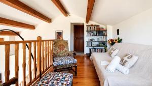 a living room with a couch and a book shelf at Piscine & Vue Mer, Maison Familiale Corse, accès cascade in Santa-Maria-Poggio +19 photos