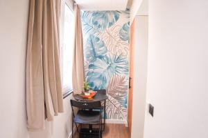 a small table in a hallway next to a window at Cuzi House in Librazhd