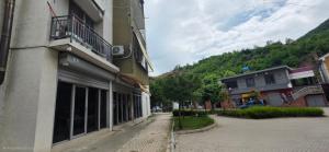 an empty street in a town with a building at Cuzi House in Librazhd