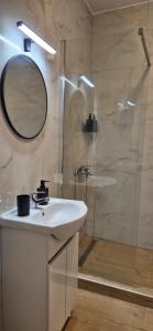 a bathroom with a sink and a shower with a mirror at Apartment K2 in Pyrgi +11 photos