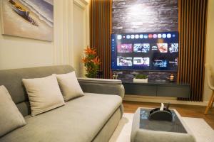 a living room with a couch and a tv at Cuzi House in Librazhd