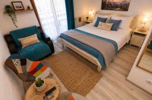 a bedroom with a large bed and a chair at Pensiunea Craiul Muntilor-Ranca in Ranca +25 photos
