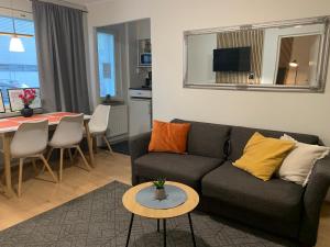 a living room with a couch and a table at StarHomes Oulu, double in Oulu